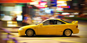 Yellow Integra Type-R Driving Through City
