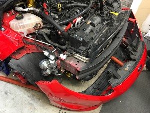 Mounting the front bumper with new brake ducts on a Fiesta ST